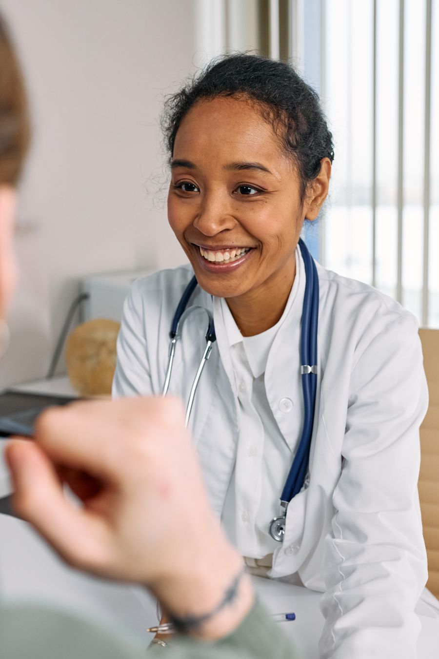 Smiling doctor consulting with a patient
